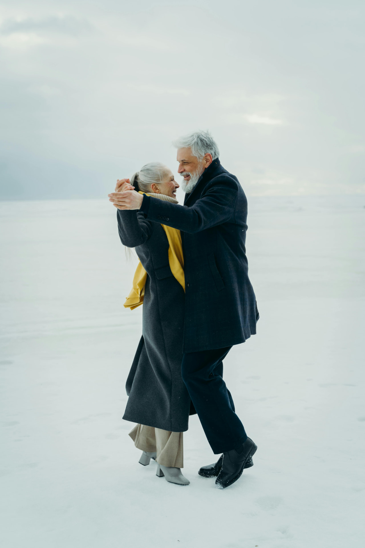 Retired couple dancing in the snow